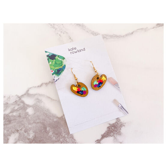Small wooden paint palette drop earrings with paint splotches in presentation card