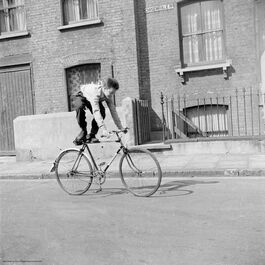 Nigel Henderson: Brian Samuels on a bicycle, Bow