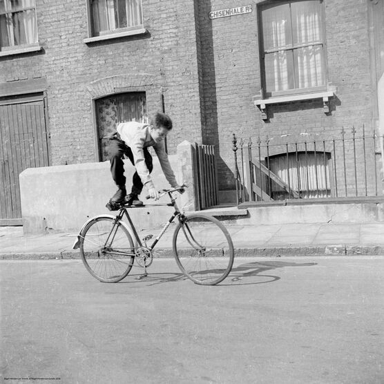 Nigel Henderson: Brian Samuels on a bicycle, Bow