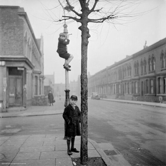 Nigel Henderson: Two unidentified children, one of which is climbing a lamp-post