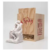 White miniature stature of a couple kissing in a wooden crate