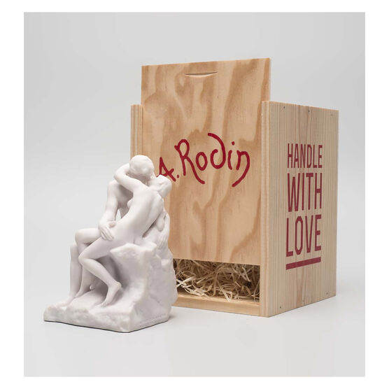 White miniature stature of a couple kissing in a wooden crate