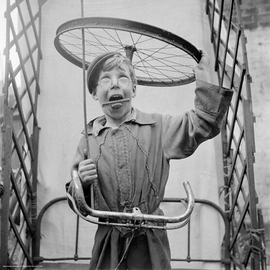 Nigel Henderson: Boy playing with bicycle parts