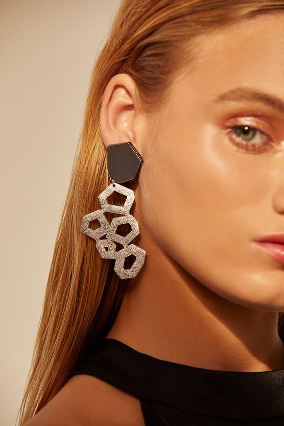 silver leather earrings worn by a model