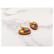 Small wooden paint palette drop earrings with paint splotches on marble background
