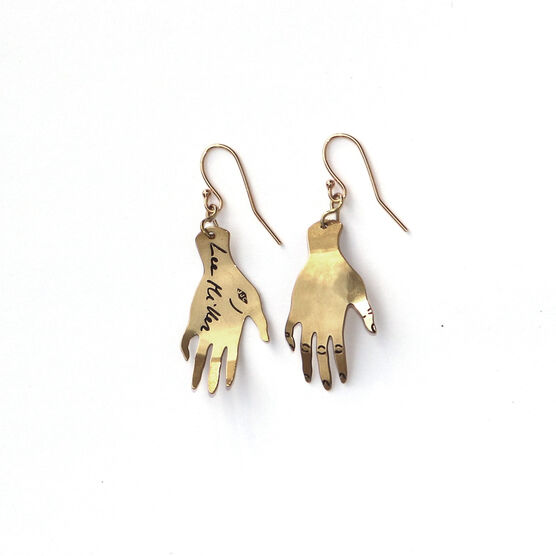 Lee Miller hands earrings