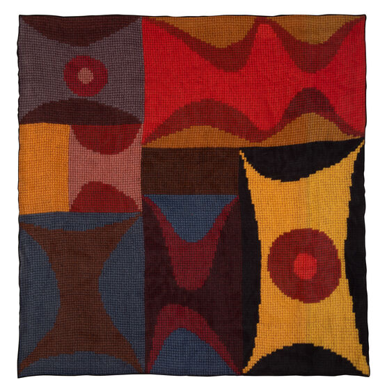 Flat large silk scarf with a print of an embroidered artwork in blues, reds, browns and yellows.