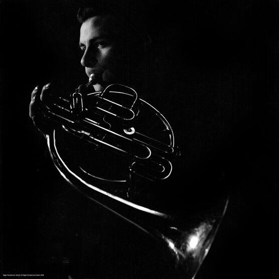 Nigel Henderson: A musician performing on a French horn