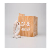 Miniature sculpture replica of two intertwined hands with a wooden packaging crate