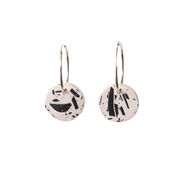 Black and white patterned circles on hoop earrings